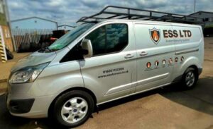 A side view of one of Eastern Security Systems silver work vans, populated with branded stickers that follow the companys brand colours. 